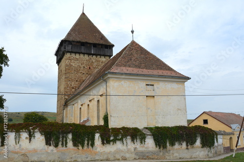 Fortified medieval saxon church in the village Barcut, Bekokten, Brekolten,Transylvania,Romania photo