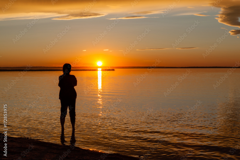 Silhouette of Woman at Beach Sunset