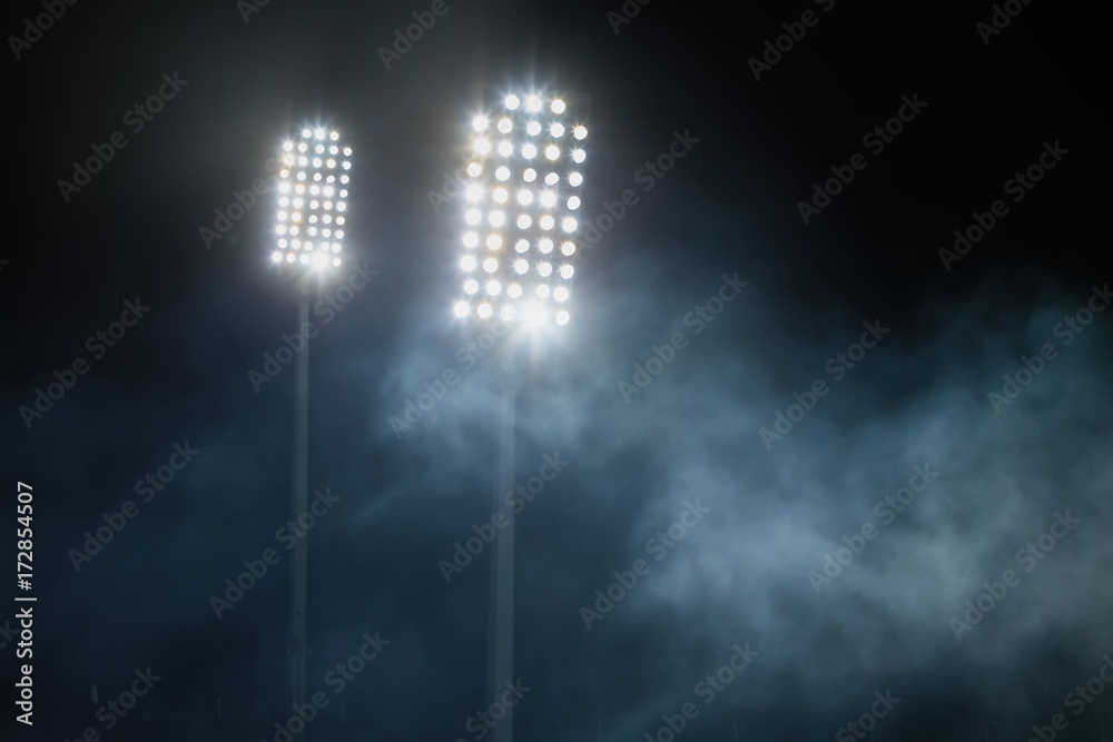 Fototapeta premium stadium lights and smoke against dark night sky background