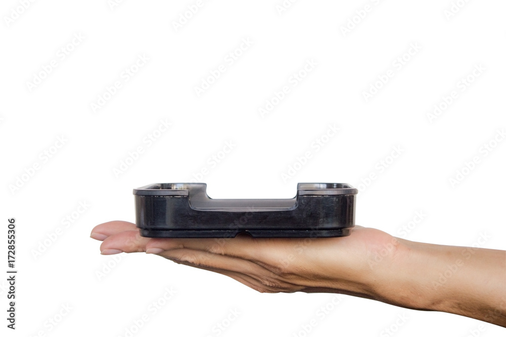 Hand holding black plate isolated on white background. Clipping path. Hand holding black plate isolated on white background. Clipping path.