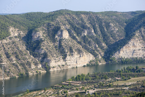 The river Ebro on its way through Mequinenza, Aragon photo