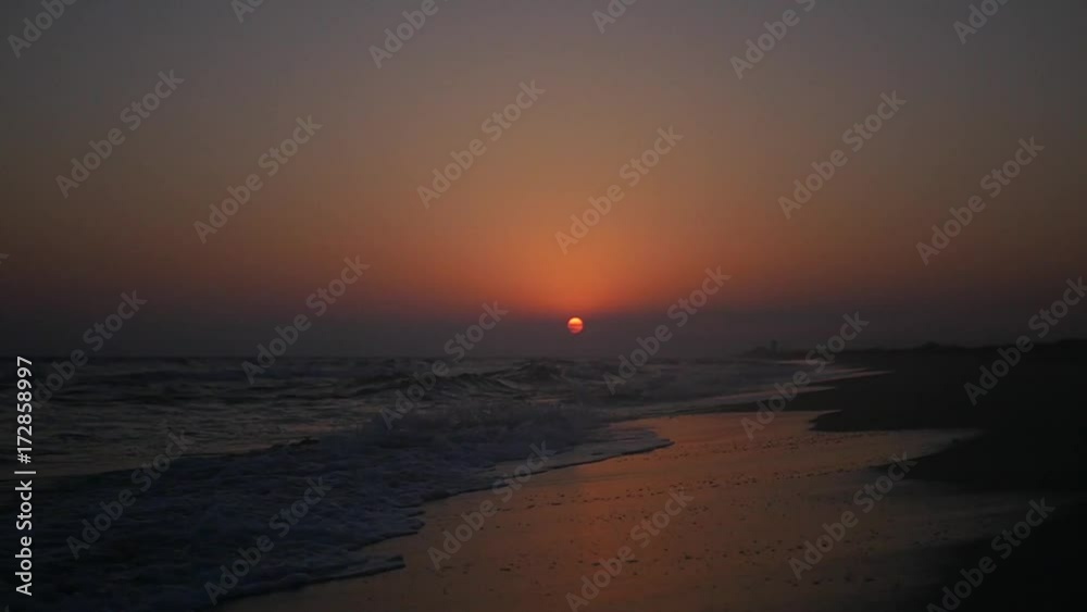 Sandy beach with waves and sea foam in the rays of the passing sun. HD, 1920x1080. slow motion. Sandy beach with waves and sea foam in the rays of the passing sun. HD, 1920x1080. slow motion.