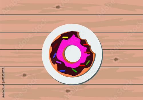 Colorful donut on wooden table