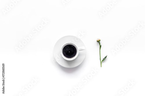 Floral pattern. Cup of coffee and buds and leaves on white background top view copyspace