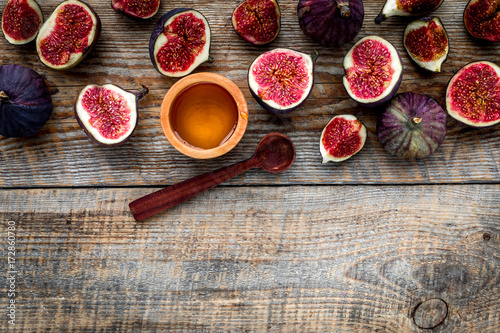 Fresh blue figs and honey on wooden background top view copyspace