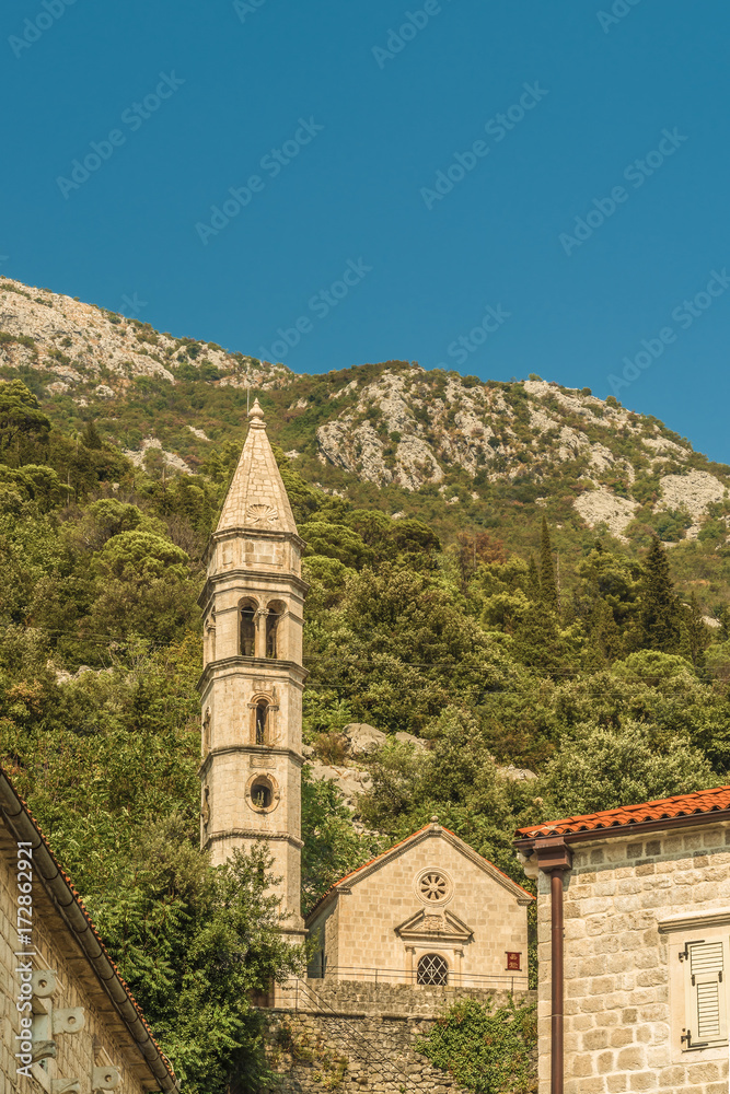 View of old church in mediterranean city in croatia Perast in kotor bay, italian venetian architecture style and white bricks.