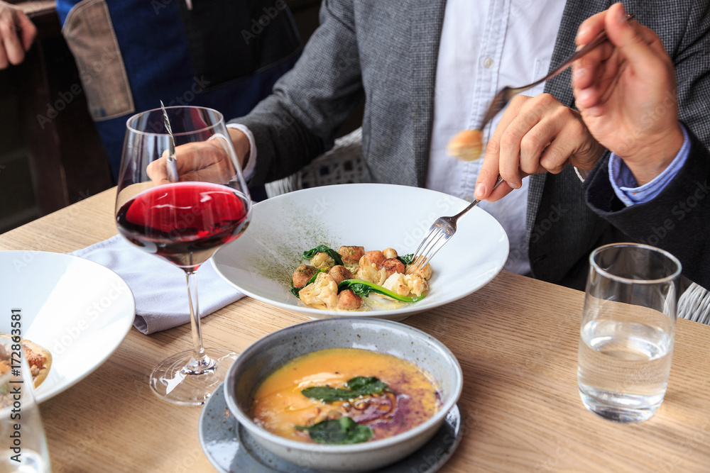 Man is eating in a restaurant and enjoying delicious food Man is eating in a restaurant and enjoying delicious food