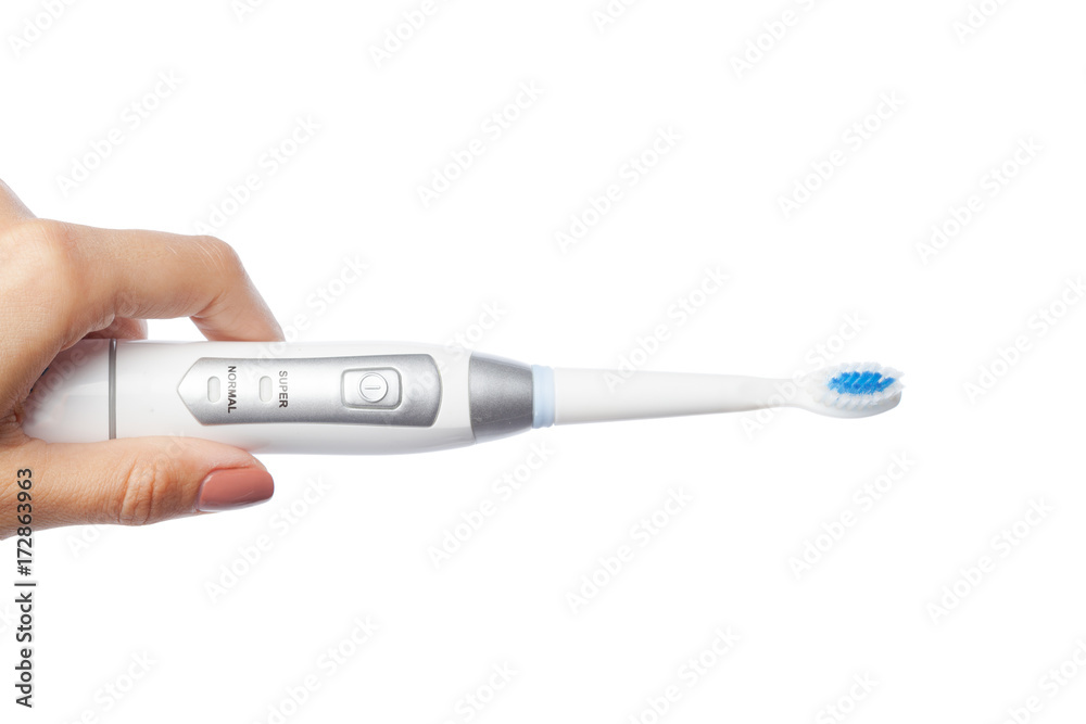 Obraz premium Woman hand holding a toothbrush isolated on white