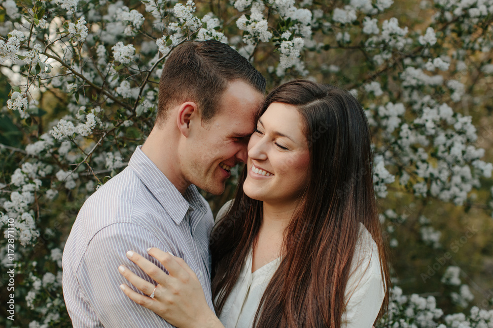 Couple Laughing in front of Flowers Couple Laughing in front of Flowers