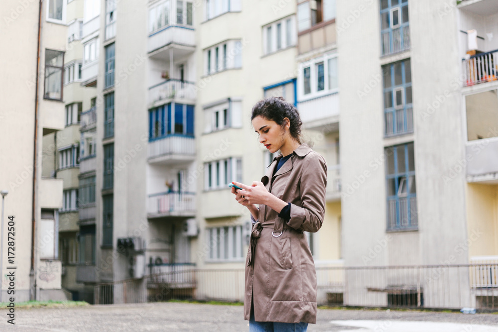 Stylish woman holding a smart phone