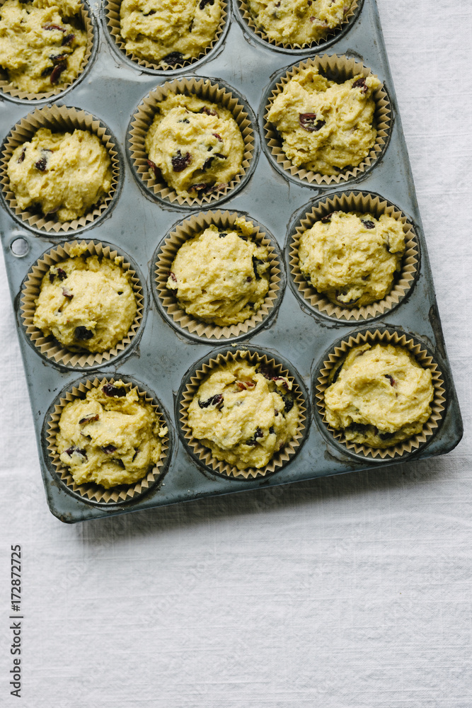 Baking tin with unbaked cranberry cornbread batter Baking tin with unbaked cranberry cornbread batter