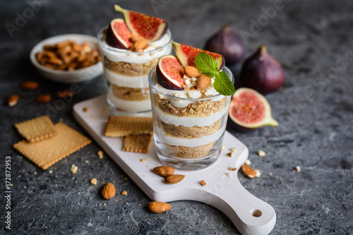 Layered mascarpone dessert with crushed vanilla biscuits, figs and almonds