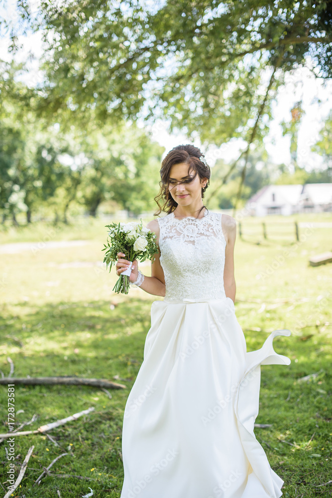 Beautiful bride outdoors on the meadow on a wedding day. Joyful moment of happiness Beautiful bride outdoors on the meadow on a wedding day. Joyful moment of happiness