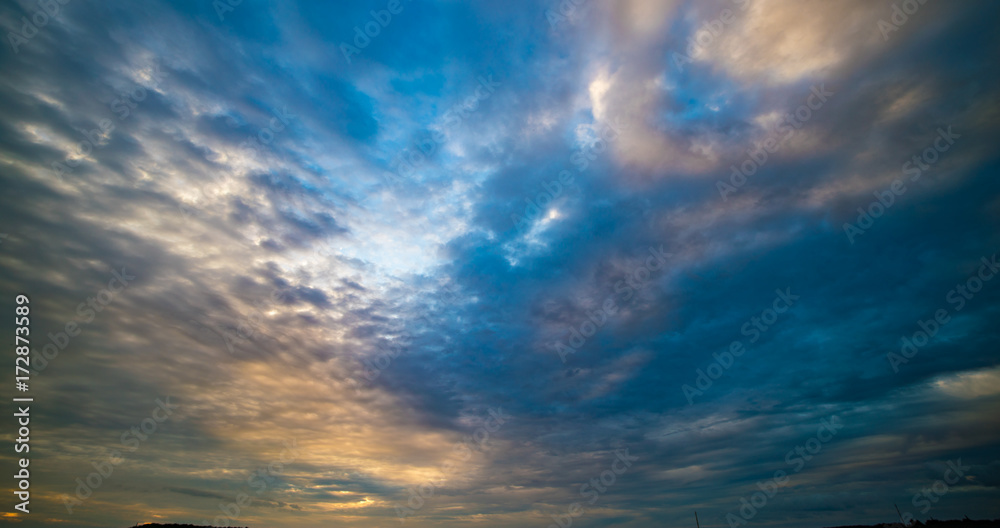 The evening sky lit by the rays of the setting sun. The sky during sunset or sunrise