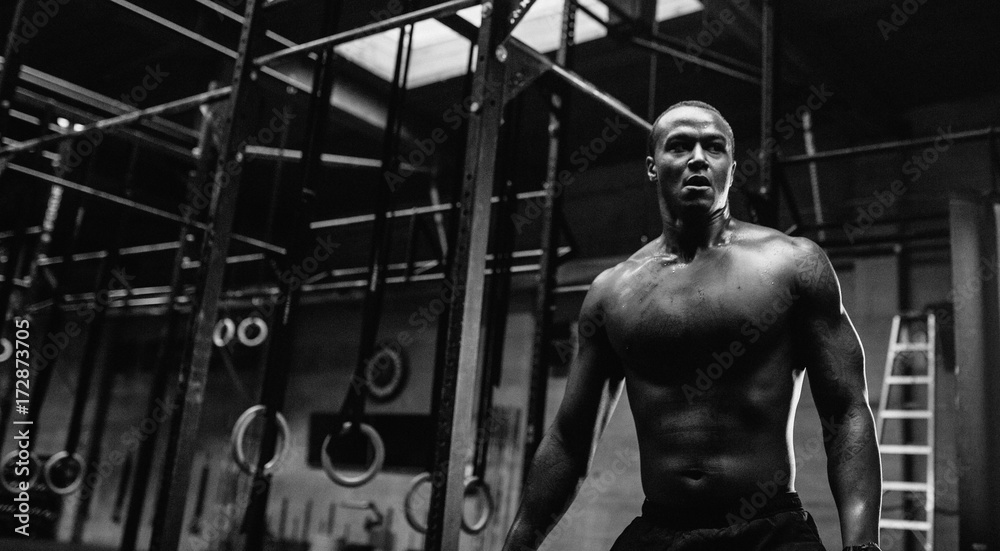 Young, fit black man training hard in fitness gym - post boxing Stock ...