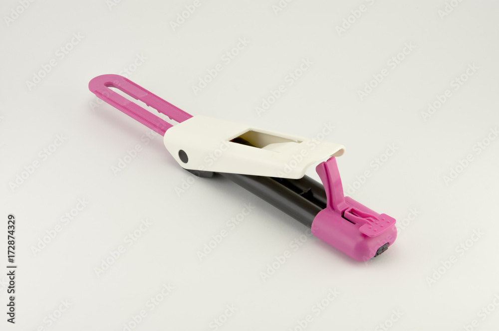 photo clicker plastic mixer dental cement close-up on a white background photo clicker plastic mixer dental cement close-up on a white background