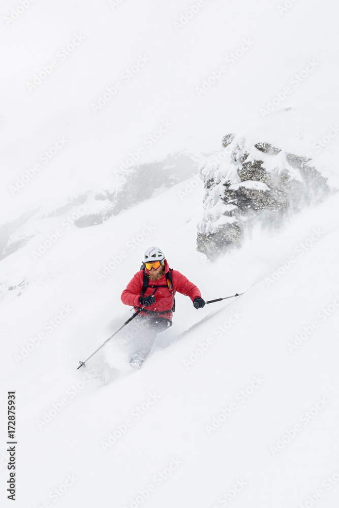 Skier taking a sharp turn splashing with snow Skier taking a sharp turn splashing with snow