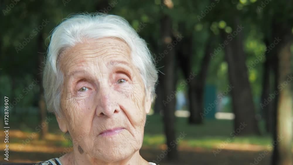 The face of a lonely elderly woman. Sad old woman close-up.