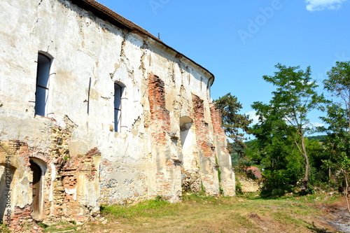 Ruins. Fortified medieval saxon evangelic church in the village Felmer, Felmern, Transylvania, Romania. The settlement was founded by the Saxon colonists in the middle of the 12th century photo