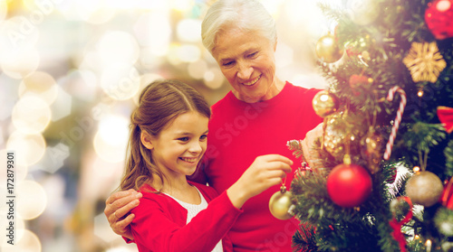 grandmother and granddaughter at christmas tree