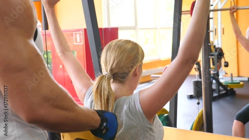 the woman is engaged in the gym with a personal trainer. 4k slow motion photo