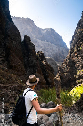 Obraz na płótnie young hipster traveller hiking through Masca Valley, Tenerife Island w salonie