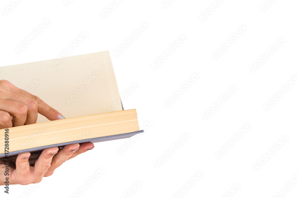 Woman's hands holding and reading a opened book isolated on the white background. Reading time. Education concept. Empty place for a text.