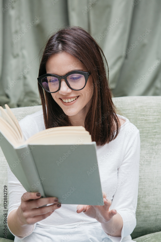 Beautiful smiling woman reading book