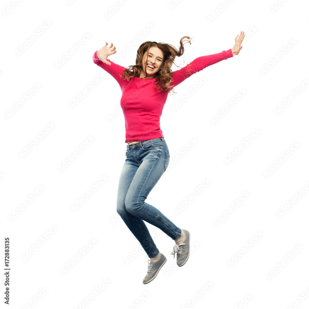 smiling young woman jumping in air smiling young woman jumping in air