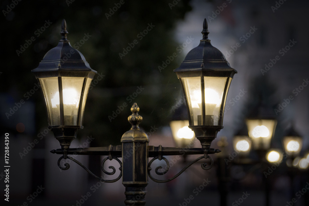 Black street lamp against a blue evening sky. Black street lamp against a blue evening sky.