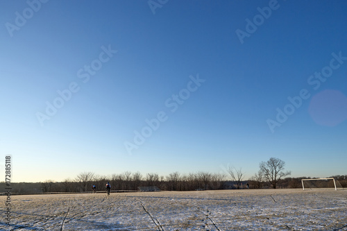 Cycling trails on snowy pitch on sunny day photo