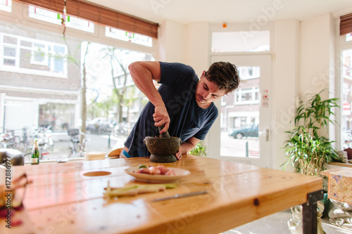 Young man cooking asian food photo