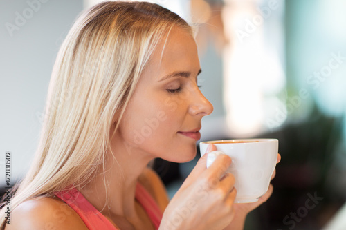 close up of woman drinking coffee at restaurant