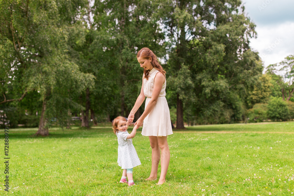 happy mother playing with baby girl at summer park happy mother playing with baby girl at summer park