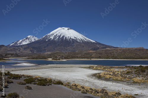 Volcanoes Parinacota and Pomerape in Lauca National Park high on the Altiplano of northern Chile. In the foreground lakes known as Lagunas de Cotacani