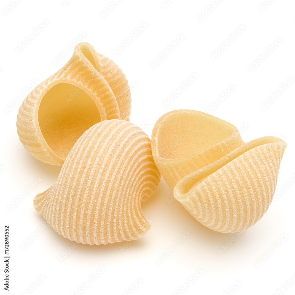 Italian lumaconi isolated on white background. Lumache, snailshell shaped pasta. Italian lumaconi isolated on white background. Lumache, snailshell shaped pasta.
