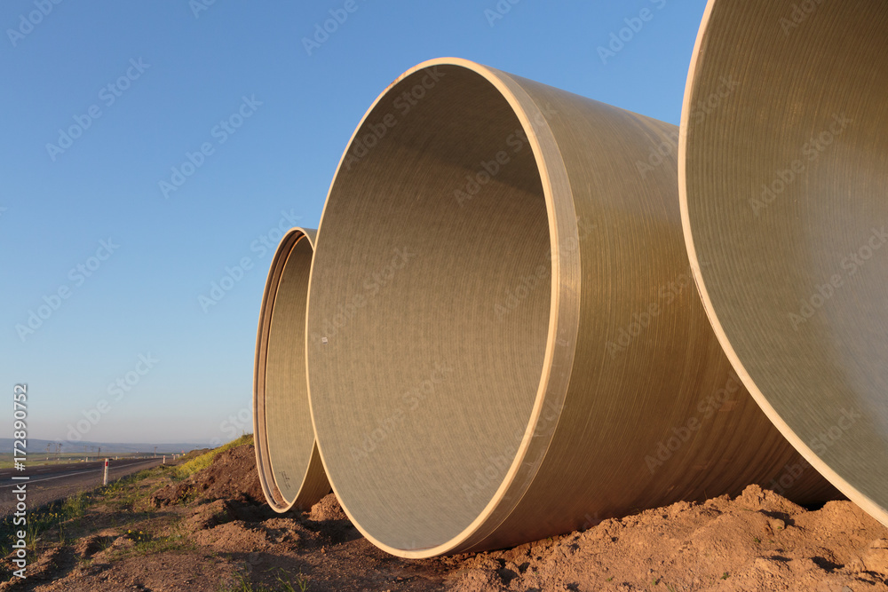 Large concrete pipes waiting for infrastructure work. Large concrete pipes waiting for infrastructure work.
