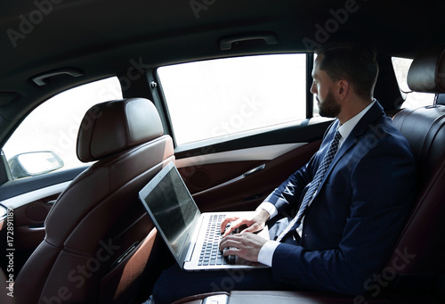 Businessman working with laptop sitting in car © ASDF