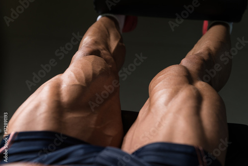 Man Doing Seated Leg Curls Exercise in Gym