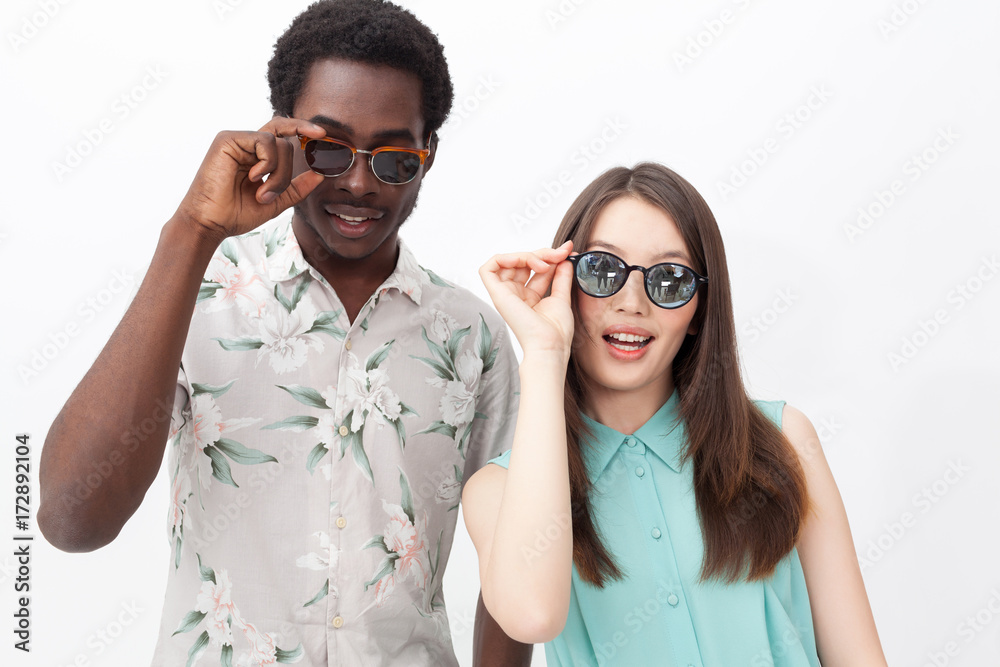 Smiling mixed couple in sunglasses