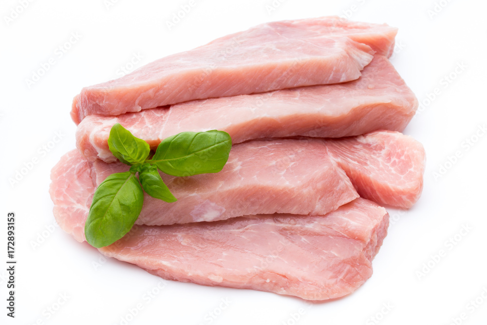 Fresh pork fillet with basil on a white background. Fresh pork fillet with basil on a white background.