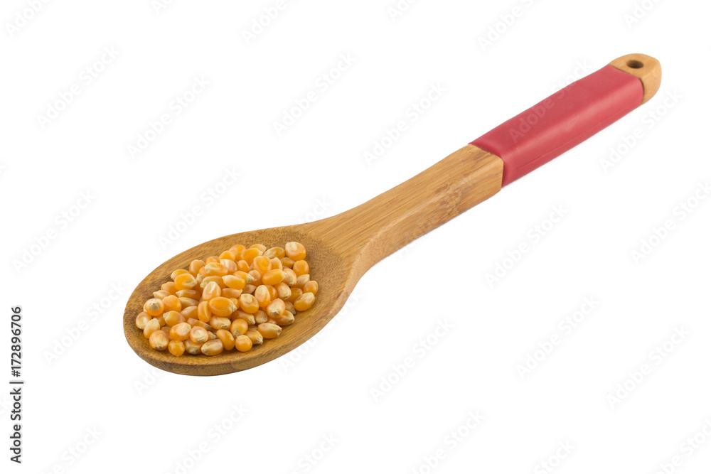 Popcorn corn. Raw grain in a spoon Popcorn corn. Raw grain in a spoon