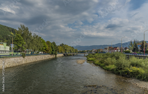 Vah river in Ruzomberok town with cloudy blue sky