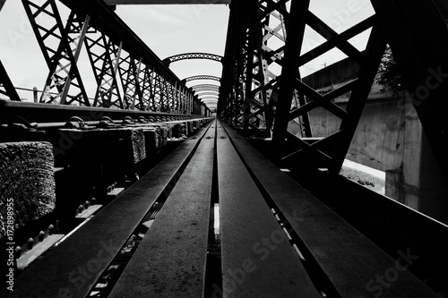 Black and white image, perspective view of old railway bridge