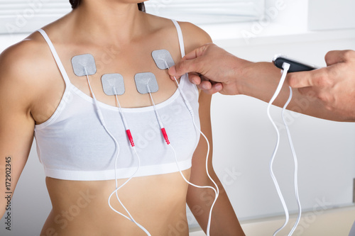 Therapist Giving Electrodes Therapy To Woman