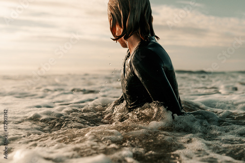 Side view of boy in ocean