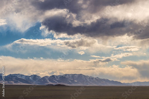 Panoramic view of plain with hills and mountains on background 