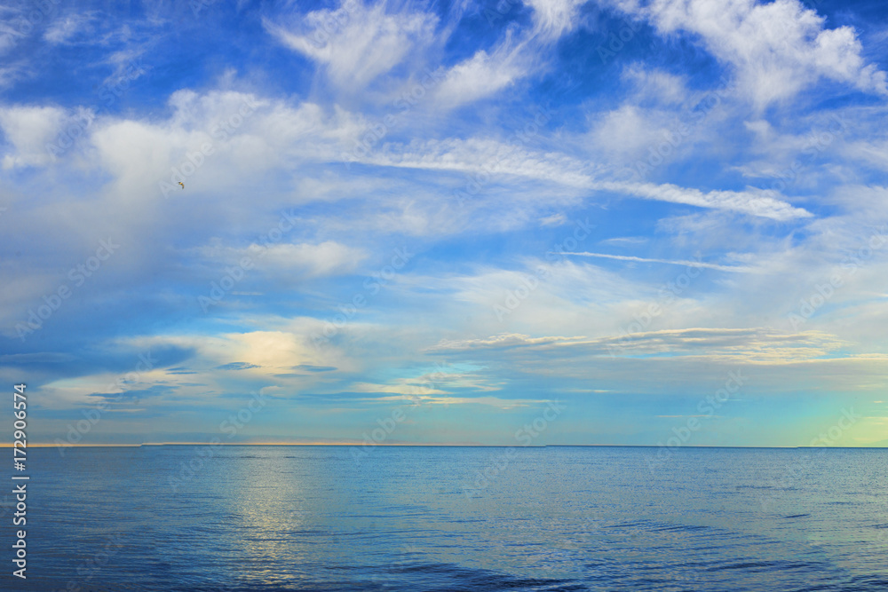 amazing view of azure sky over rippled surface of cold sea at sunrise
