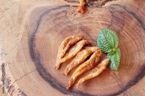 Fried fish is tasty on wood background photo