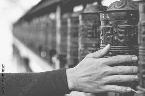 abstract background of hand spinning prayer wheels with copy space and blurred background photo